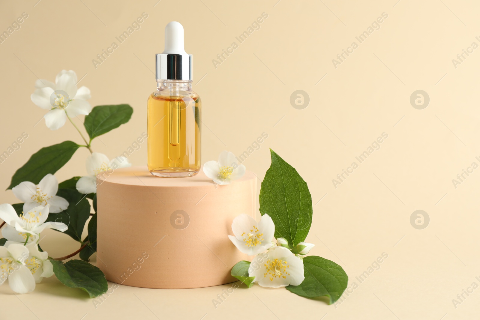 Cosmetic product and jasmine flowers on beige background. Space for text Photo of Cosmetic product and jasmine flowers on beige background. Space for text