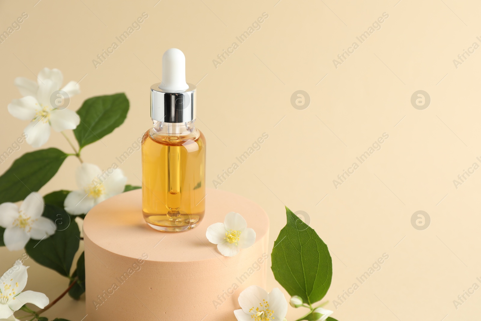 Cosmetic product and jasmine flowers on beige background, closeup. Space for text Photo of Cosmetic product and jasmine flowers on beige background, closeup. Space for text
