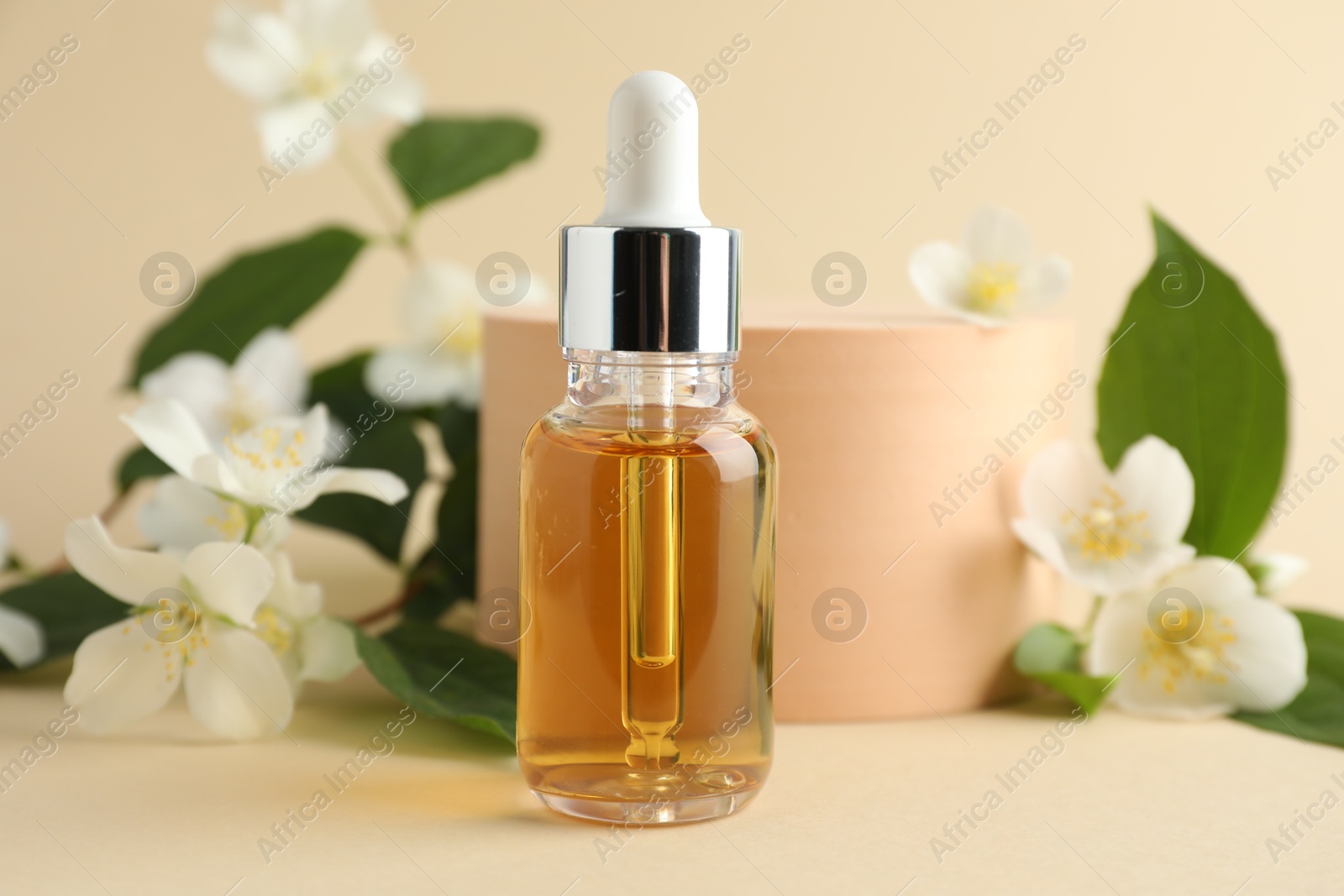 Cosmetic product and jasmine flowers on beige background, closeup Photo of Cosmetic product and jasmine flowers on beige background, closeup