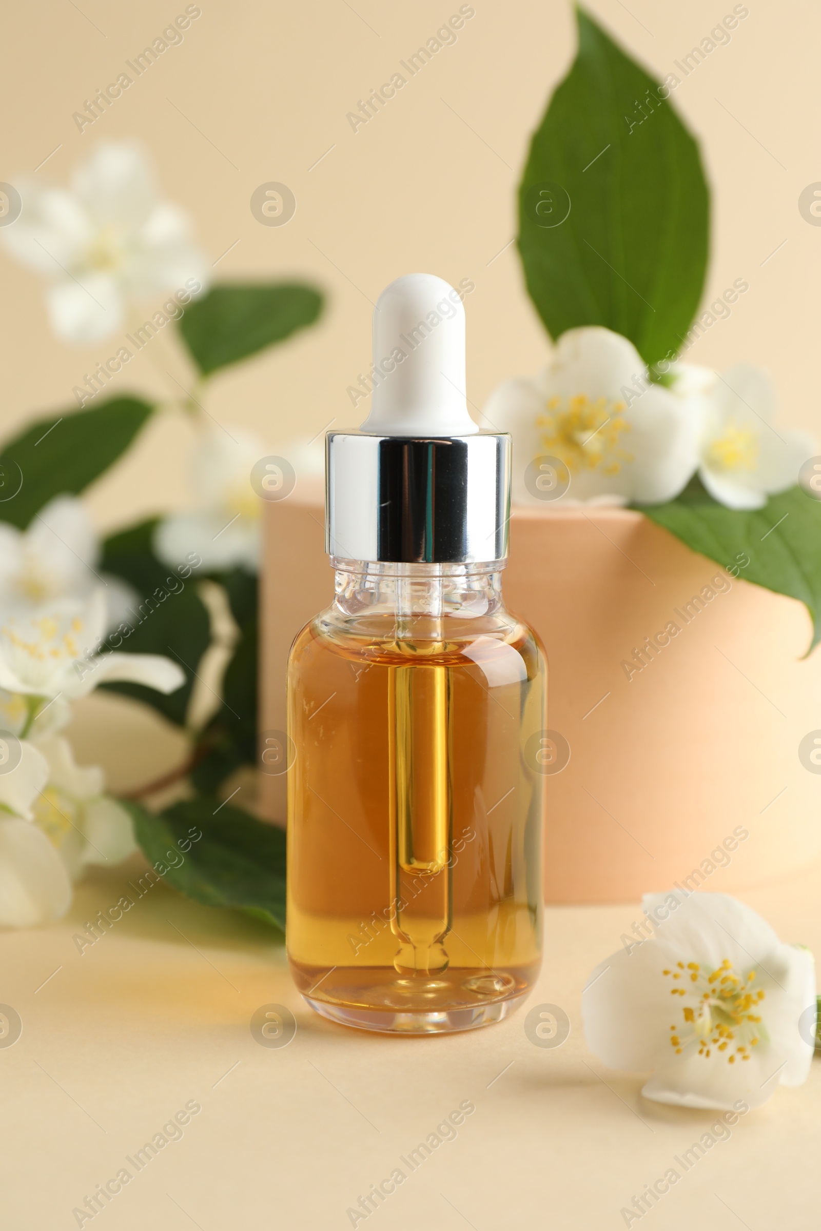 Cosmetic product and jasmine flowers on beige background, closeup Photo of Cosmetic product and jasmine flowers on beige background, closeup