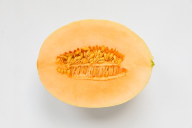 Photo of Half of juicy melon on white background, top view