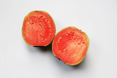 Photo of Halves of juicy guava on white background, top view