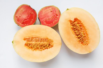 Photo of Ripe juicy tropical fruits on white background, flat lay