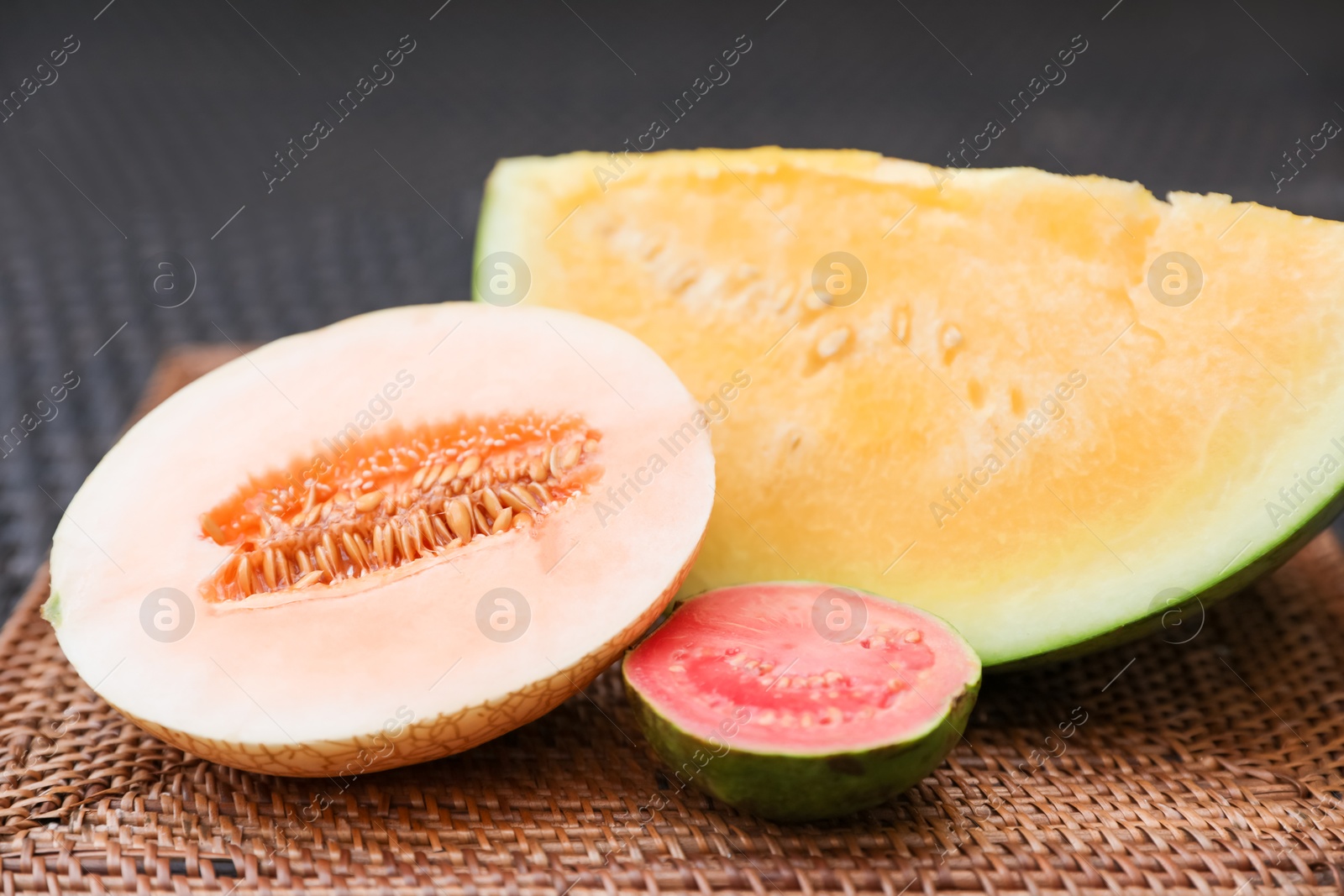 Ripe juicy tropical fruits on wicker table, closeup Photo of Ripe juicy tropical fruits on wicker table, closeup