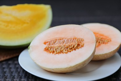 Photo of Ripe juicy tropical fruits on wicker table, closeup