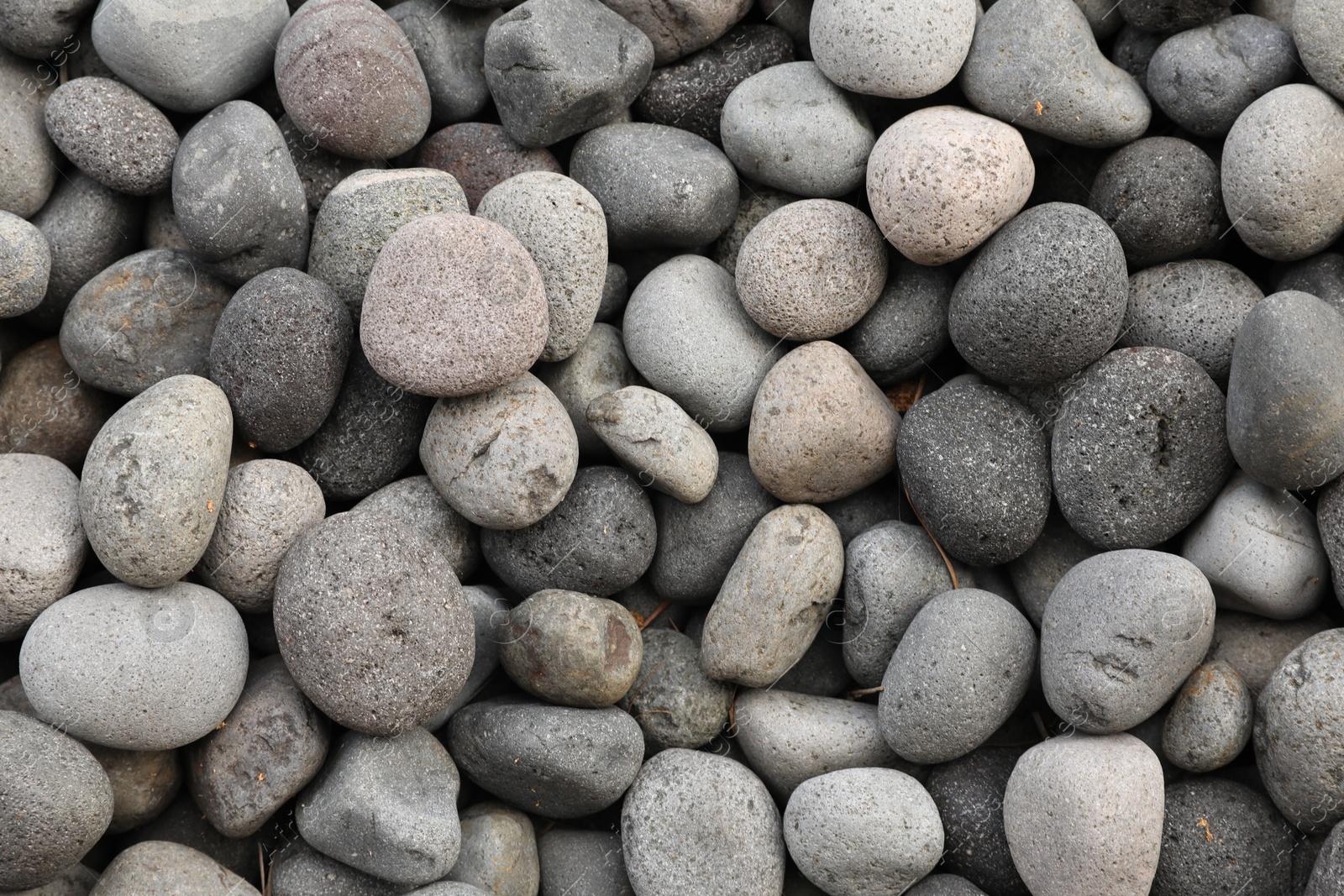 Many different pebbles as background, top view Photo of Many different pebbles as background, top view