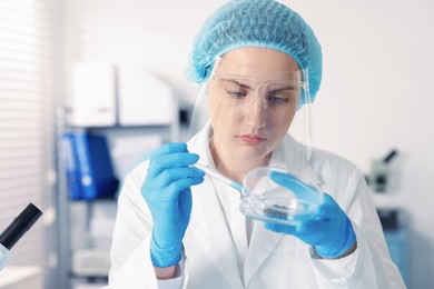 Photo of Scientist working with sample in Petri dish in laboratory