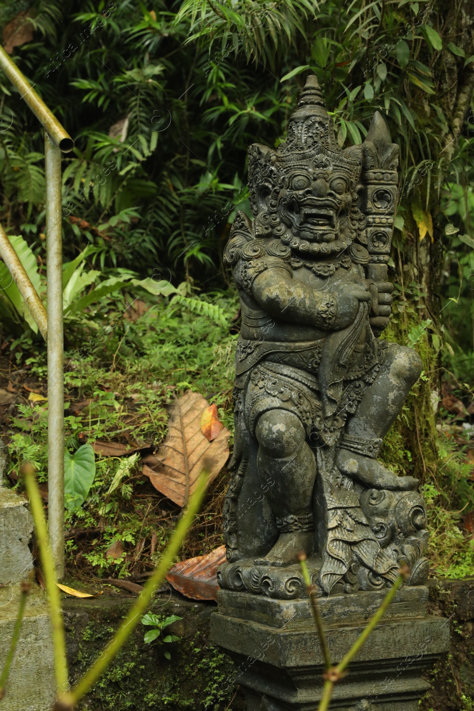 Bali, Indonesia - May 24, 2025: Beautiful Dvarapala statue and green plants outdoors Photo of Bali, Indonesia - May 24, 2025: Beautiful Dvarapala statue and green plants outdoors