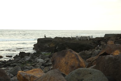 Photo of Bali, Indonesia - May 27, 2025: View of wavy sea and rocky beach