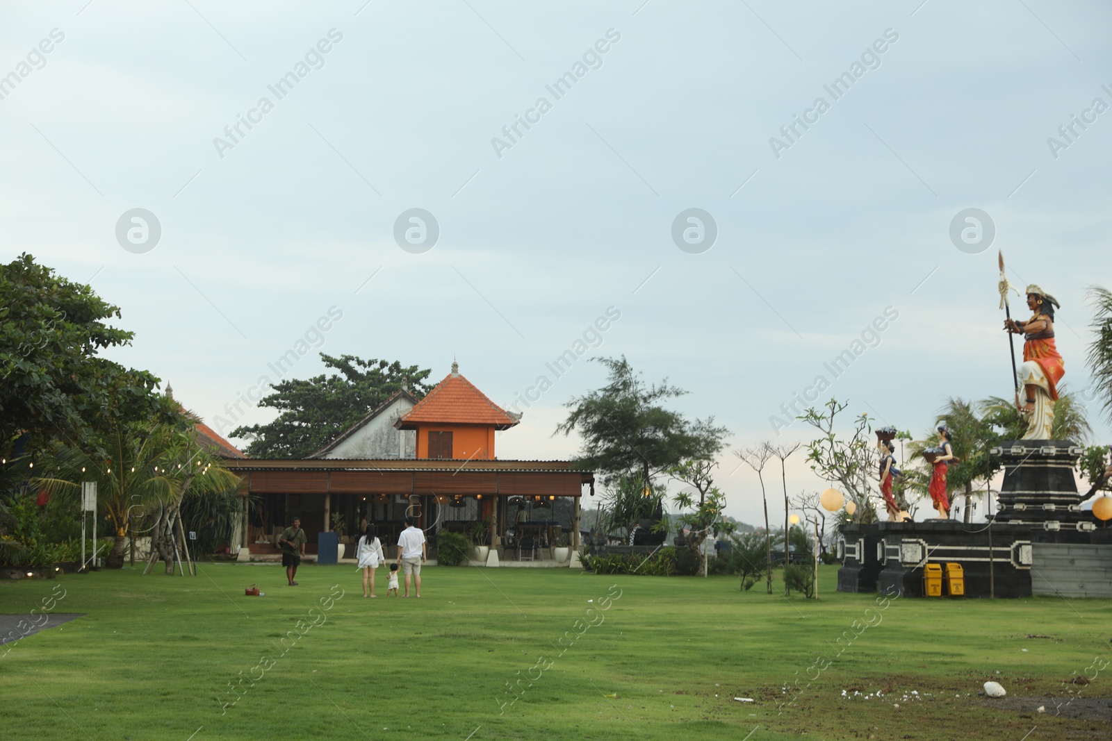 Bali, Indonesia - May 27, 2025: View of people, statues, cafe and different green plants Photo of Bali, Indonesia - May 27, 2025: View of people, statues, cafe and different green plants