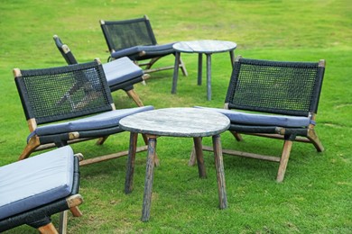 Photo of Chairs and tables on green grass outdoors