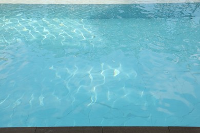 Photo of Clear water with ripples in outdoor swimming pool, above view