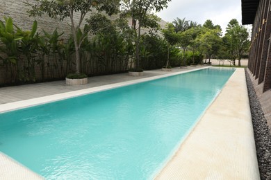 Photo of Outdoor swimming pool and green plants at luxury resort