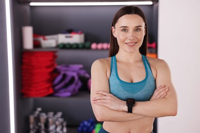 Photo of Beautiful woman wearing sportswear in fitness studio, space for text