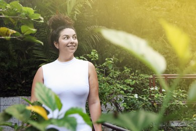 Photo of Portrait of happy woman in tropical park