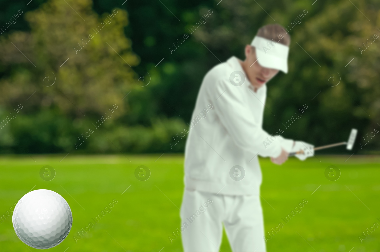 Golfer hitting ball with club on course, selective focus Image of Golfer hitting ball with club on course, selective focus