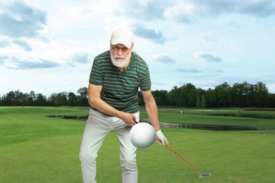 Image of Man with club playing golf on green course