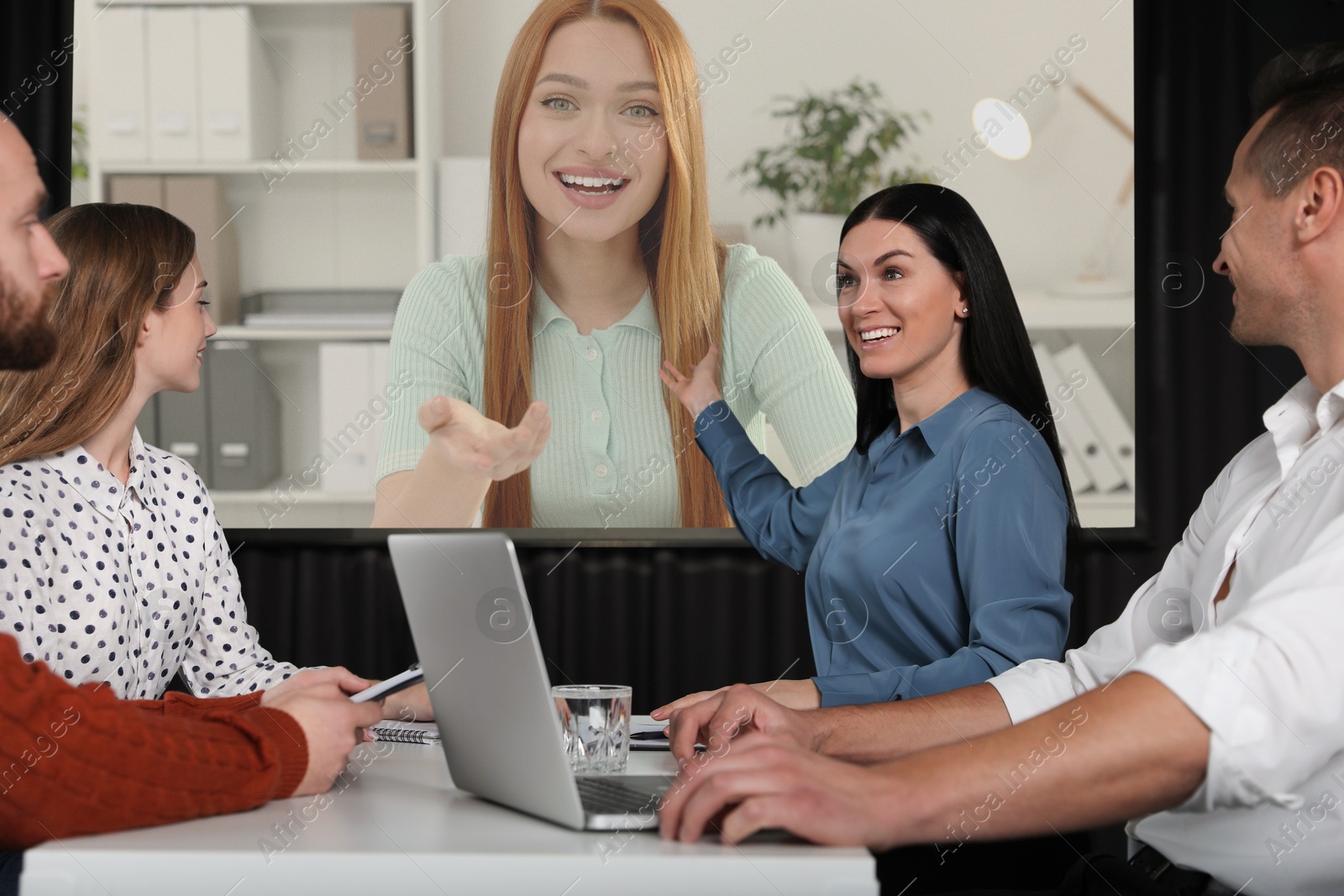 Group of people participating in business conference indoors. Speaker on projection screen Image of Group of people participating in business conference indoors. Speaker on projection screen
