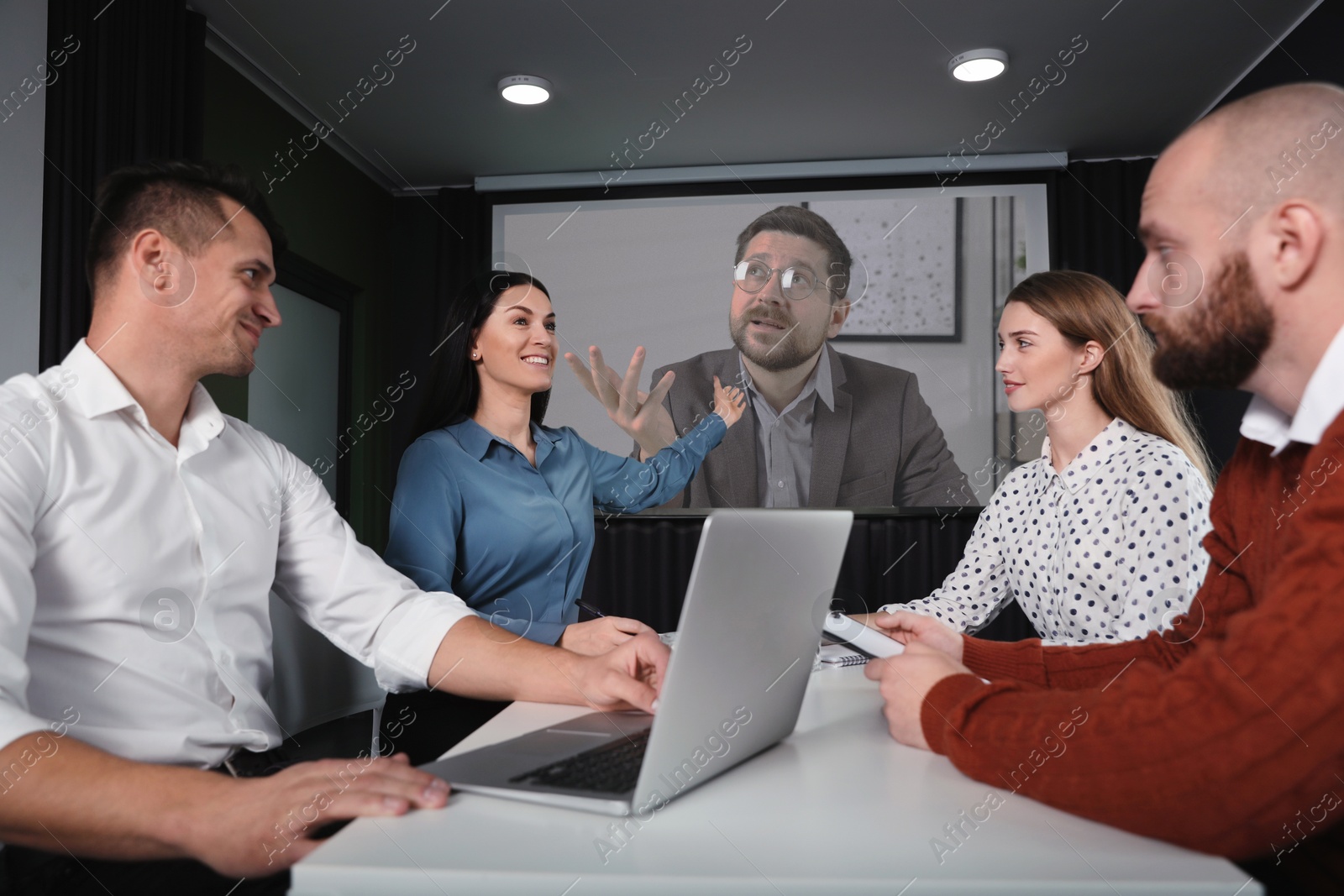 Group of people participating in business conference indoors. Speaker on projection screen Image of Group of people participating in business conference indoors. Speaker on projection screen