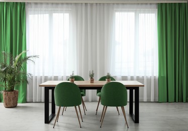 Image of Dining room interior with green color accent