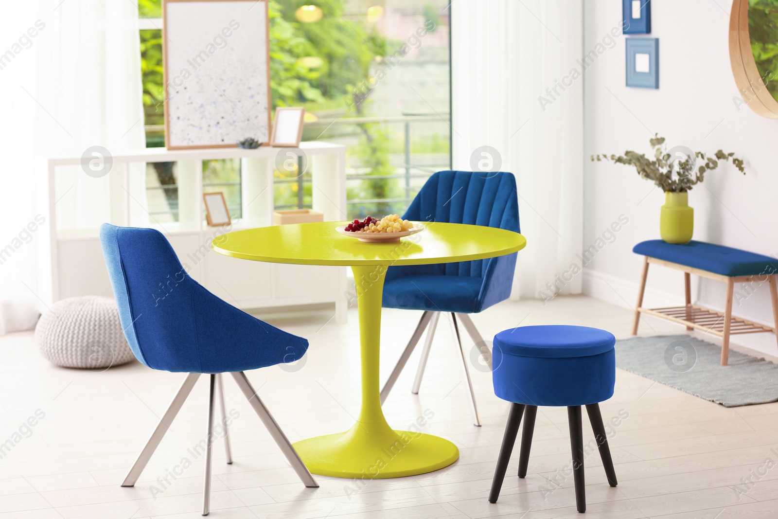 Yellow dining table and blue chairs in room. Interior design Image of Yellow dining table and blue chairs in room. Interior design