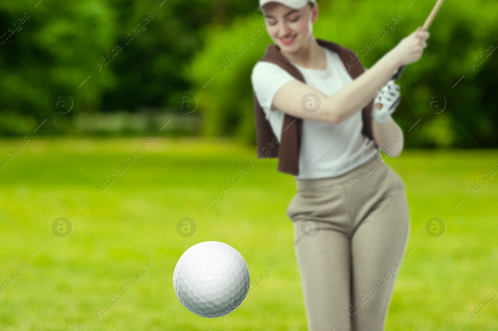 Golfer hitting ball with club on course, selective focus Image of Golfer hitting ball with club on course, selective focus
