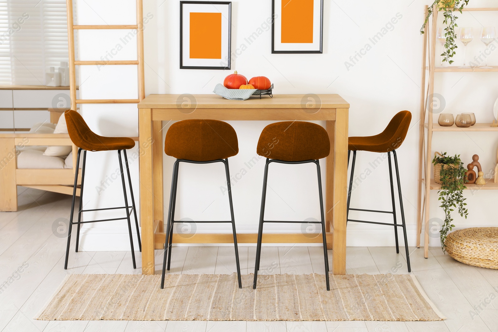 Dining table and orange chairs in room. Interior design Image of Dining table and orange chairs in room. Interior design