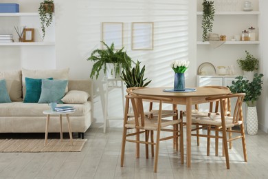 Image of Dining table and chairs in room. Interior design