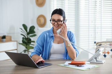 Photo of Travel agent working at wooden table in office