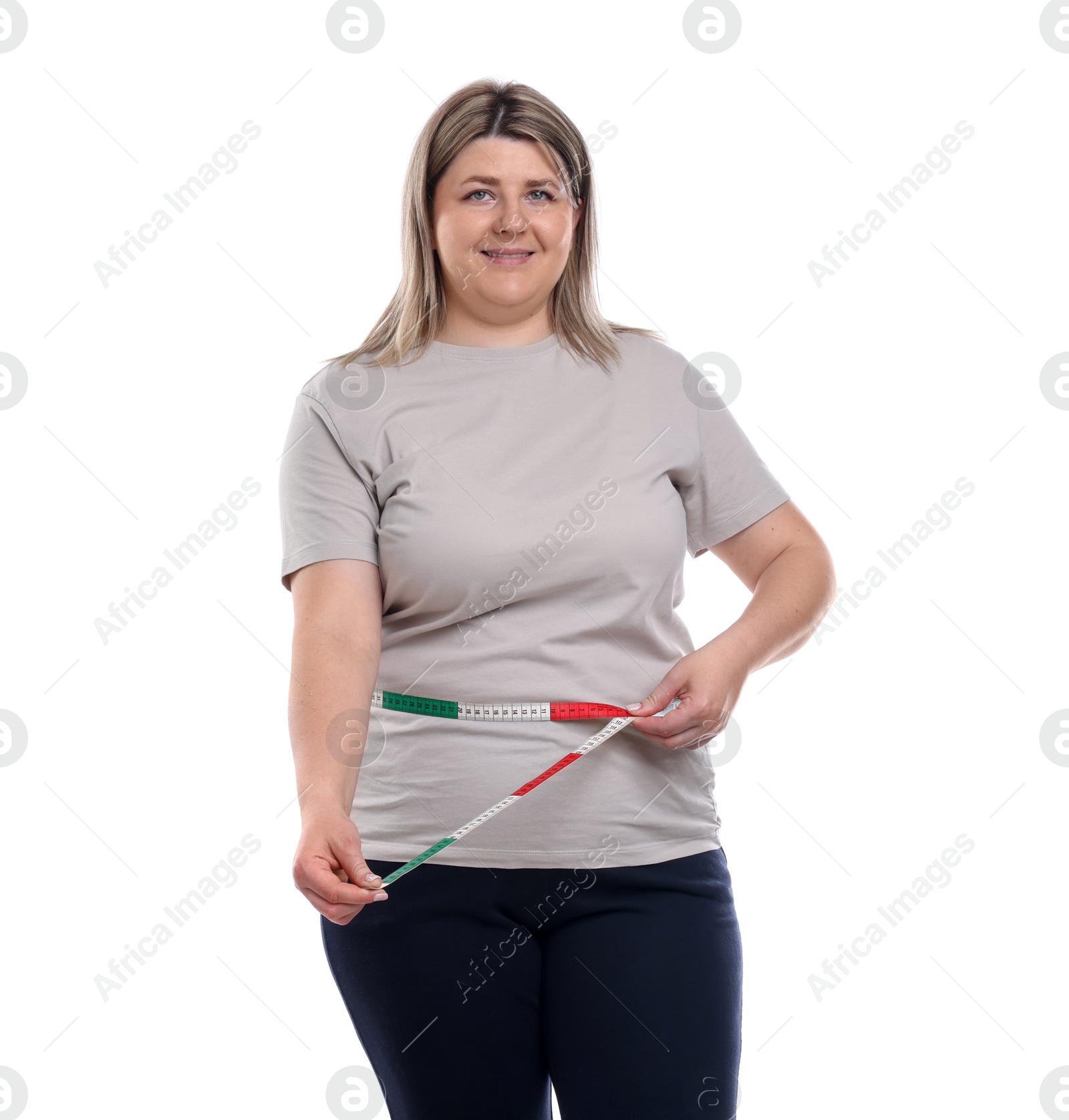 Weight loss. Plus size woman measuring waist with tape on white background Photo of Weight loss. Plus size woman measuring waist with tape on white background