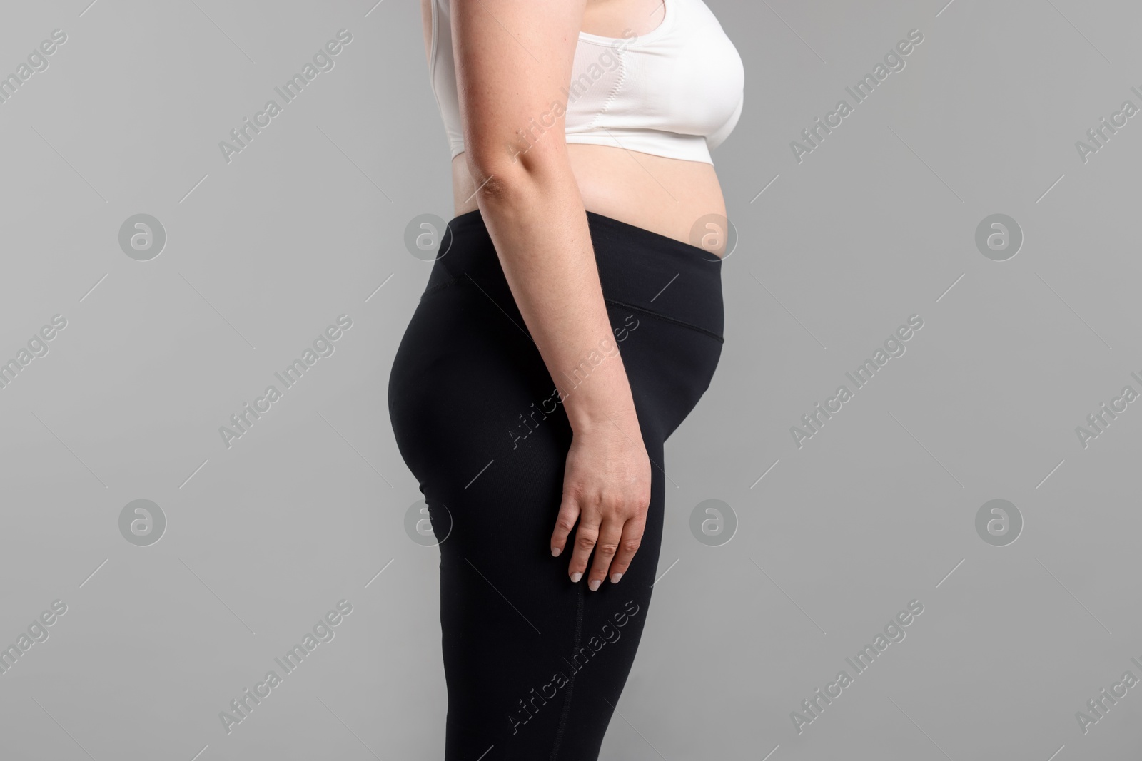 Weight loss. Plus size woman on gray background, closeup Photo of Weight loss. Plus size woman on gray background, closeup