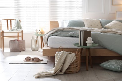 Photo of Comfortable bed with soft linens and decor in stylish room. Home textile