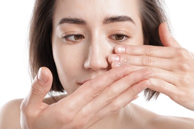 Photo of Woman putting in contact lens on white background, closeup
