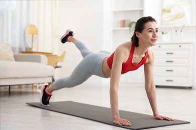 Photo of Woman doing plank exercise at home. Sport and healthy lifestyle