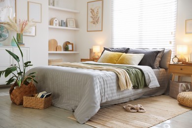 Photo of Comfortable bed with soft linens and blankets in room. Home textile