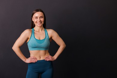 Photo of Portrait of professional trainer on black background. Space for text