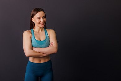 Photo of Portrait of professional trainer on black background. Space for text