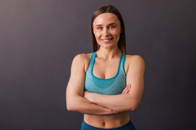 Photo of Portrait of professional trainer on black background. Space for text