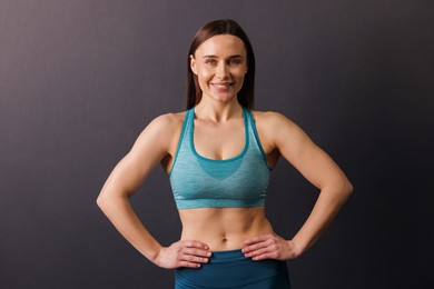 Photo of Portrait of professional trainer on black background