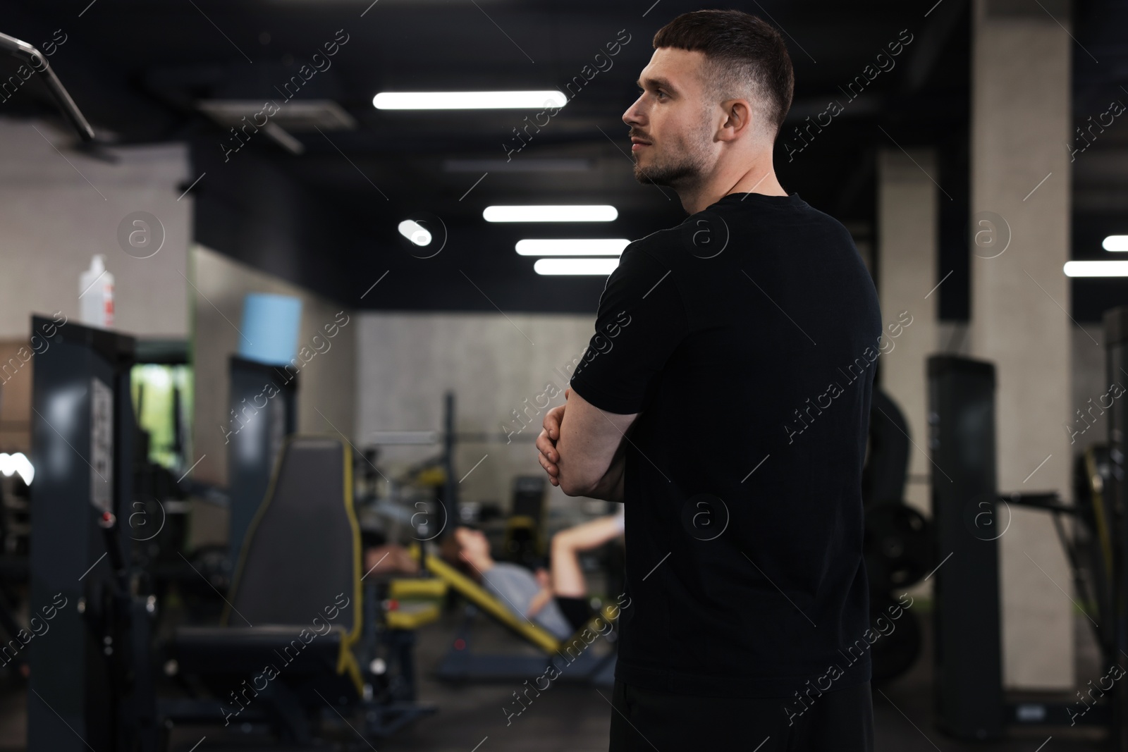 Professional personal trainer in sport center. Space for text Photo of Professional personal trainer in sport center. Space for text