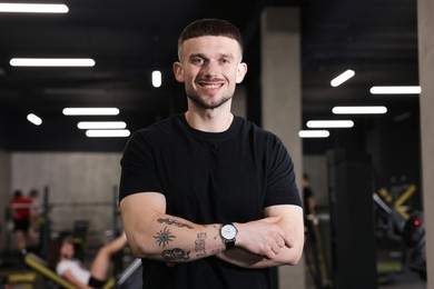 Photo of Portrait of professional personal trainer in sport center