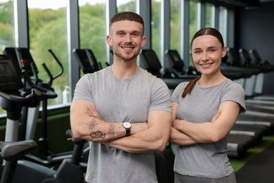 Photo of Portrait of personal trainers in sport center