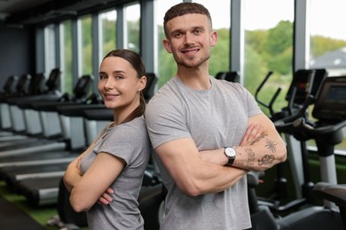Photo of Portrait of personal trainers in sport center