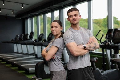 Photo of Portrait of personal trainers in sport center. Space for text
