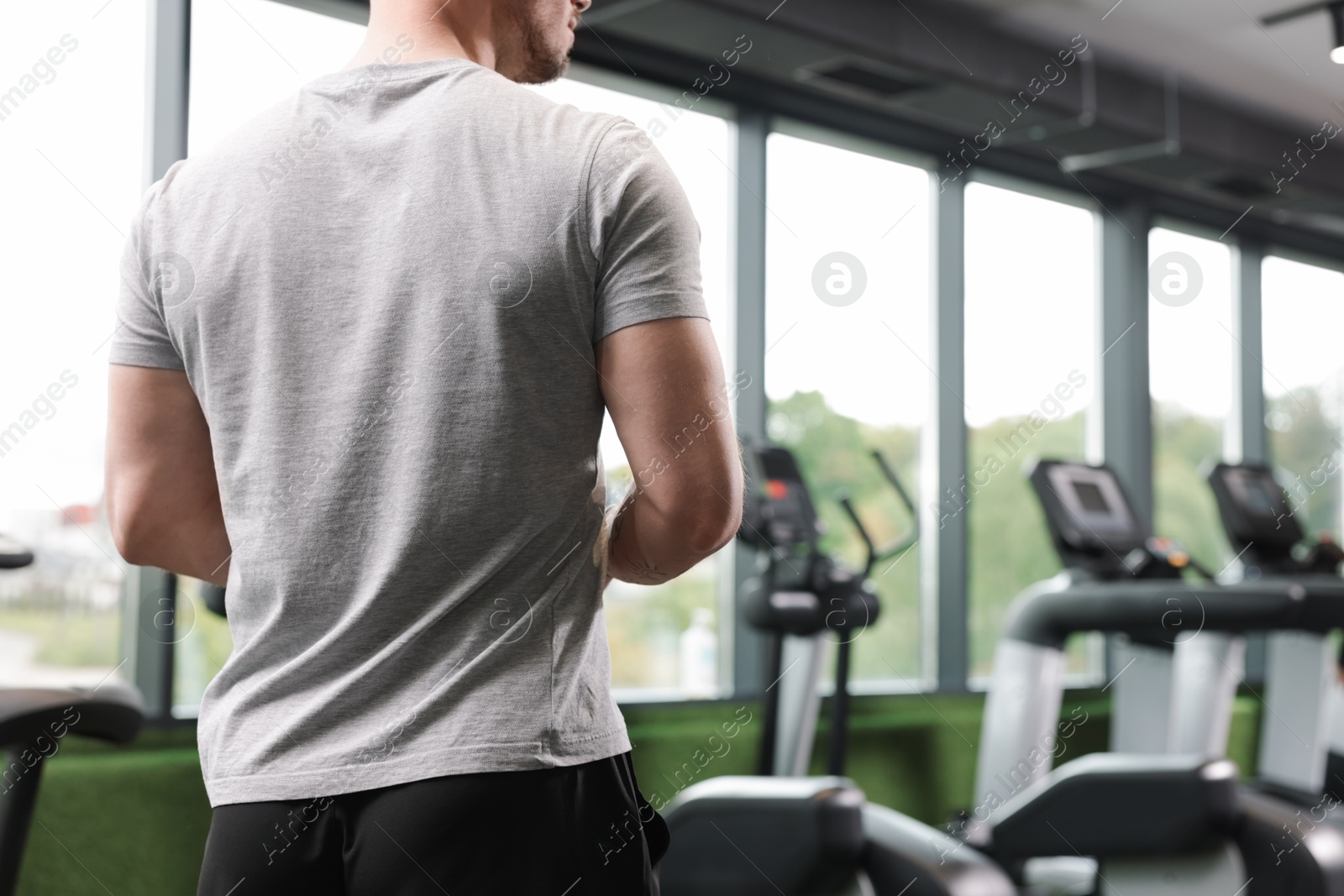 Personal trainer in sport center, back view Photo of Personal trainer in sport center, back view