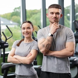Photo of Portrait of personal trainers in sport center