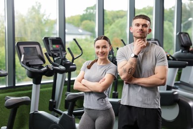 Photo of Portrait of personal trainers in sport center