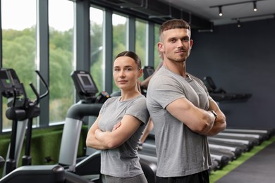 Photo of Portrait of personal trainers in sport center