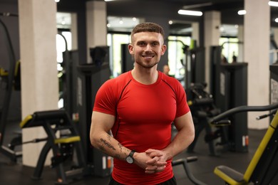 Photo of Portrait of professional personal trainer in gym