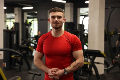 Photo of Portrait of professional personal trainer in gym